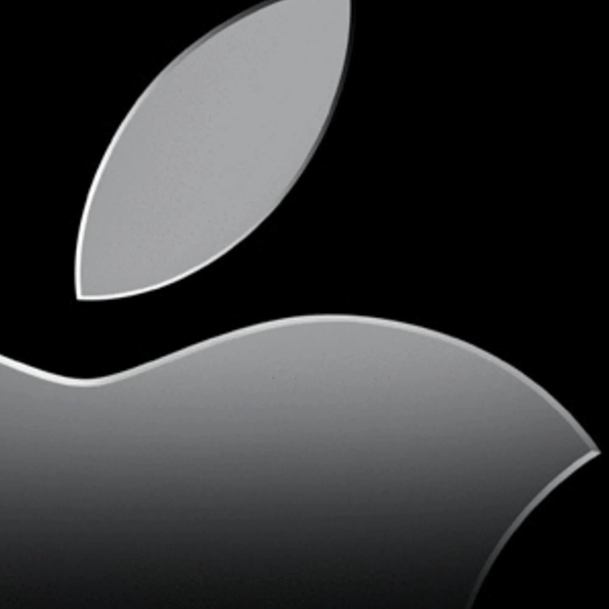 The Apple logo in monochrome against black background, symbolizing the company's recent mobile attribution changes.