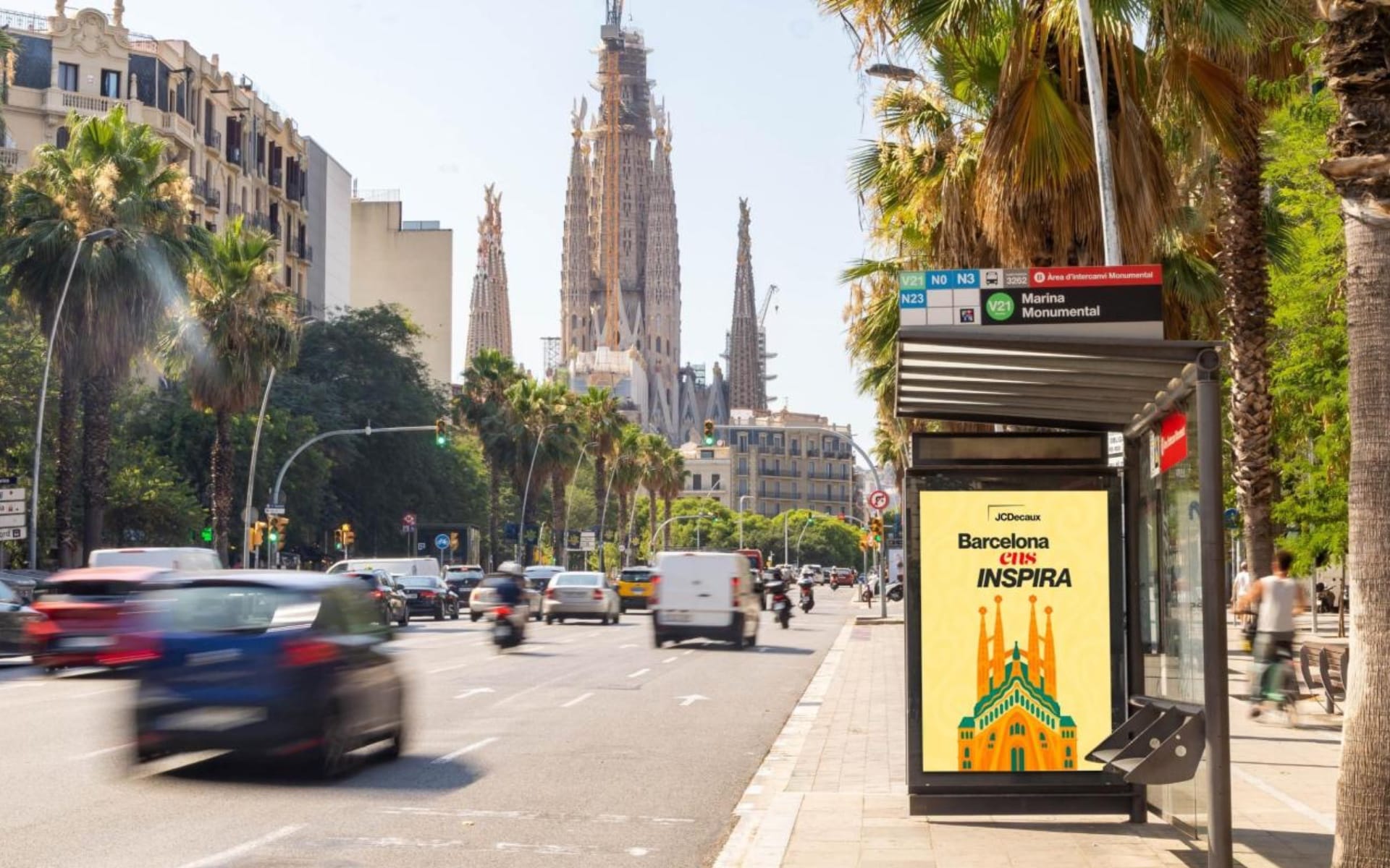 JCDecaux bus shelter in Barcelona displaying digital advertising with Sagrada Familia backdrop