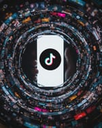TikTok app surrounded by endless spiral of content illustrating infinite scroll addiction