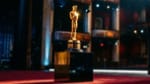 Golden Oscar statuette on red carpet stage, 98th Academy Awards ceremony at Dolby Theatre 2026.