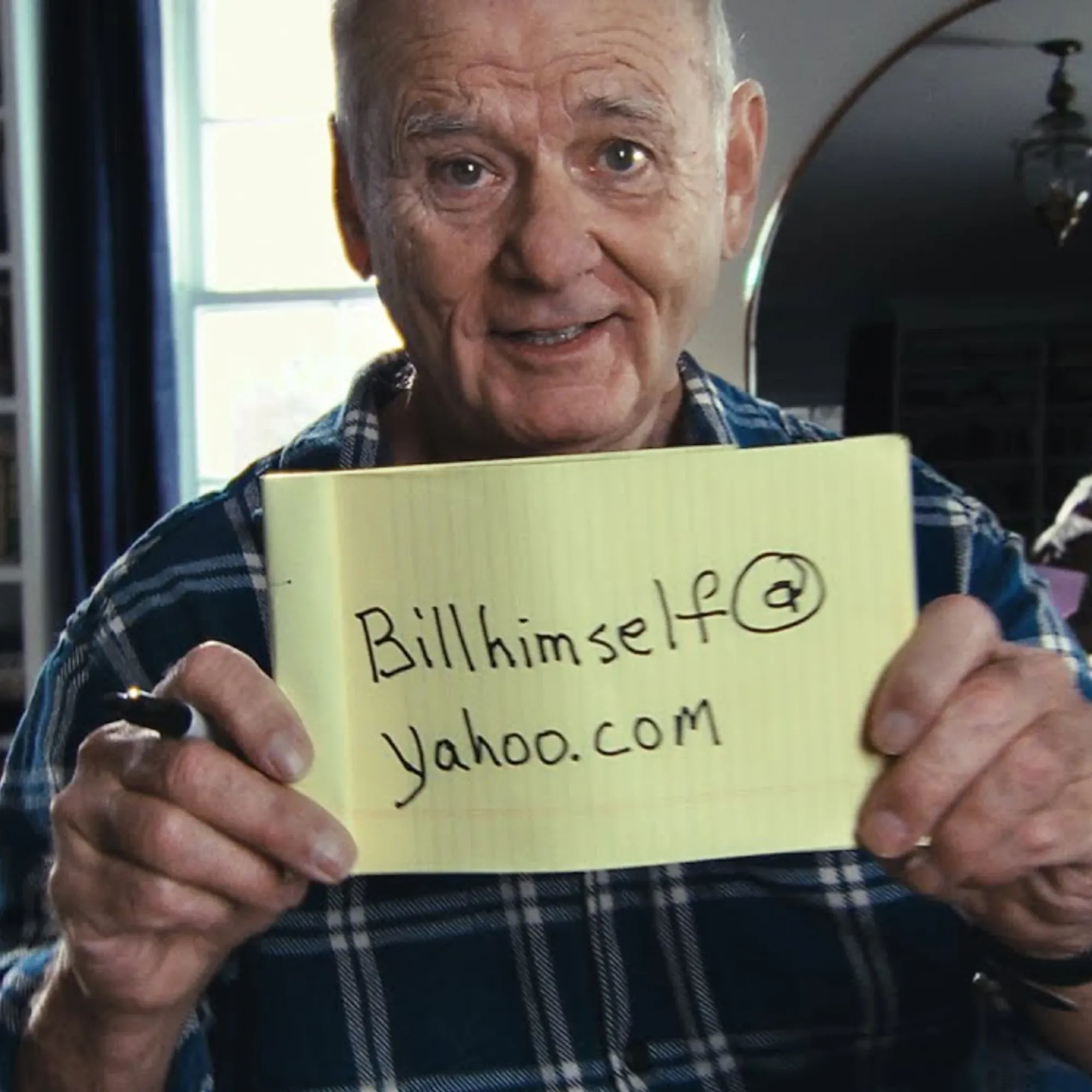 Bill Murray holds up a yellow notepad showing his Yahoo email address in a still from Yahoo's 2025 Super Bowl ad