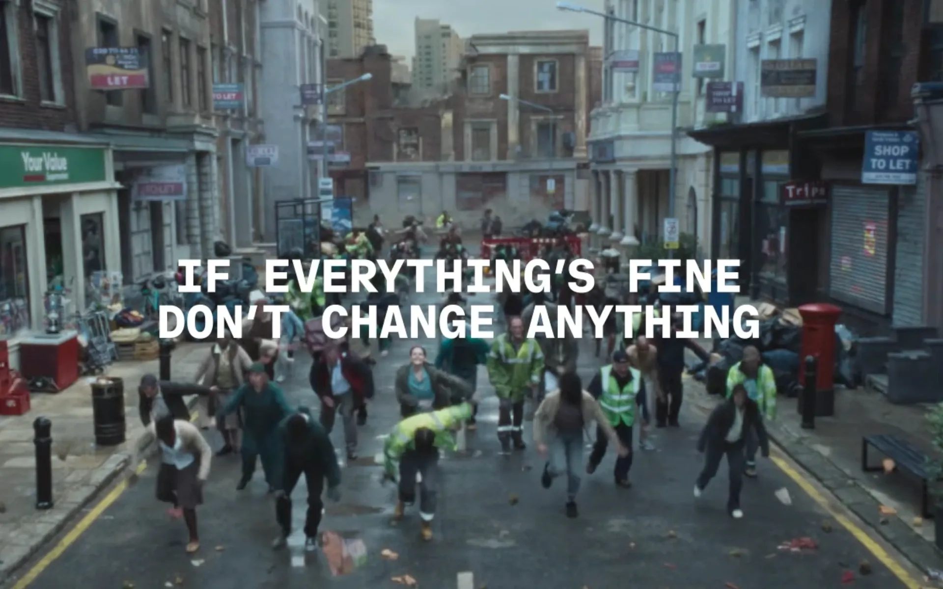 Coinbase's "Everything Is Fine" ad shows UK street scene with workers dancing amid urban decay and chaos.