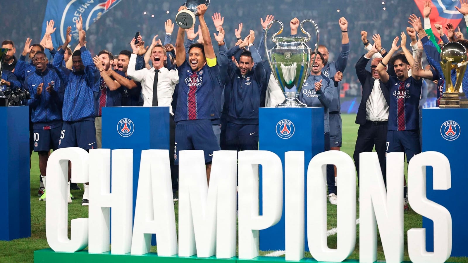 PSG players celebrate with the UEFA Champions League trophy on the pitch