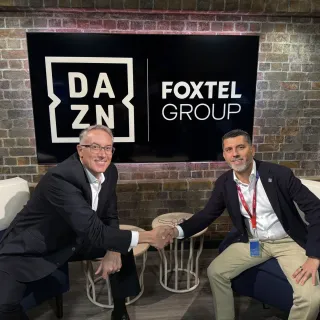DAZN and Foxtel Group CEOs shake hands after completing landmark AU$3.4 billion acquisition deal