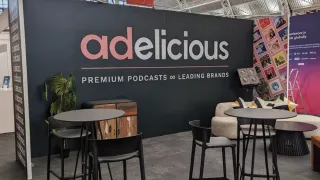 Adelicious podcast network booth showcasing premium podcast advertising solutions at industry event