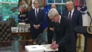 Apple CEO Tim Cook presents 24-karat gold gift to President Trump in Oval Office ceremony