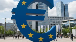 Euro symbol sculpture in European financial district representing Bulgaria's currency adoption for digital commerce.