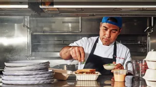 DoorDash restaurant kitchen preparing delivery orders for retail media advertising. AI generated