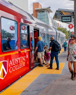 CapMetro rail transit platform in Austin with commuters boarding red train at modern station