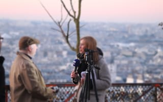 Journalist filming on-location reportage as publishers shift from volume content to feet-on-ground reporting