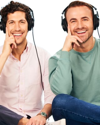 Two men wearing headphones smile confidently, hosts of The Best One Yet podcast, New York.