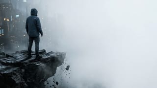 A figure stands at a crumbling cliff edge as a digital city fades into fog below.