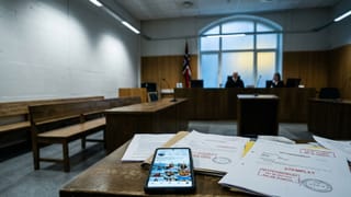 Smartphone with influencer feed on courtroom table, legal documents stamped, judges in background.