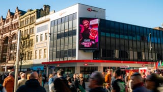 Open Media LED screen displaying a Coca-Cola ad in a busy UK city centre street.