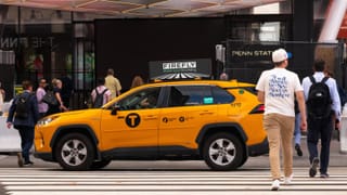 Firefly digital car top screen on a NYC taxi near Penn Station displaying programmatic OOH ad