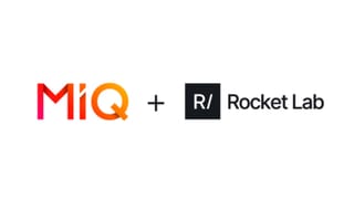 MiQ and Rocket Lab logos side by side announcing the acquisition deal, April 2026.