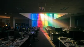 Empty publisher newsroom bathed in Google's colours as search traffic dependency drains revenue