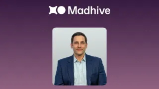 Luke Valvano, new CFO of Madhive, against a purple background with the Madhive logo.