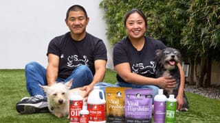Vital Pet Life co-founder Kyle Yamamoto and his partner pose with their dogs and the brand's product lineup.