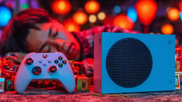 Xbox console and controller amid colorful lights as Microsoft ends Movies & TV store sales July 2025