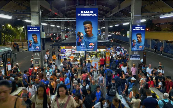 Digital DOOH screens display Pepsi ads in busy Brazilian transit hub with RZK media network branding