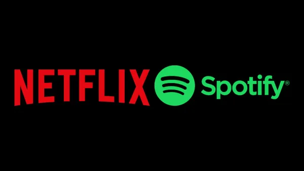 Netflix and Spotify logos on black background announcing video podcast partnership deal