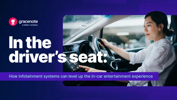 Driver using in-car infotainment system while navigating, showcasing connected vehicle technology.