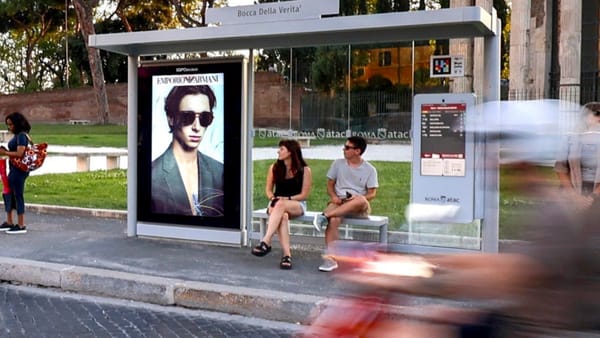 IGPDecaux digital street furniture displays Emporio Armani ad at Rome bus stop near Bocca della Verità.