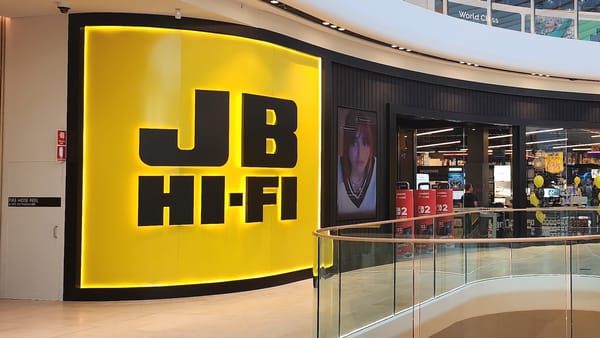 JB Hi-Fi store entrance in Australian shopping mall with digital signage screens visible