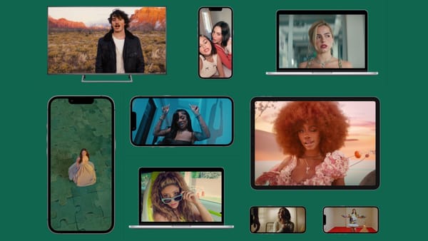 Vevo music videos playing across TV, tablet, laptop, and mobile screens on green background