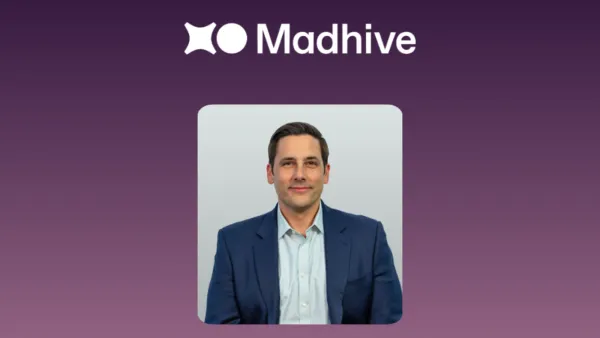 Luke Valvano, new CFO of Madhive, against a purple background with the Madhive logo.