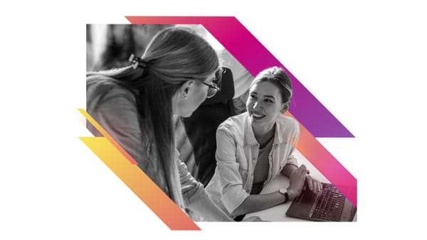 Two marketing professionals discussing agency strategy at a laptop, Zeta Global branding